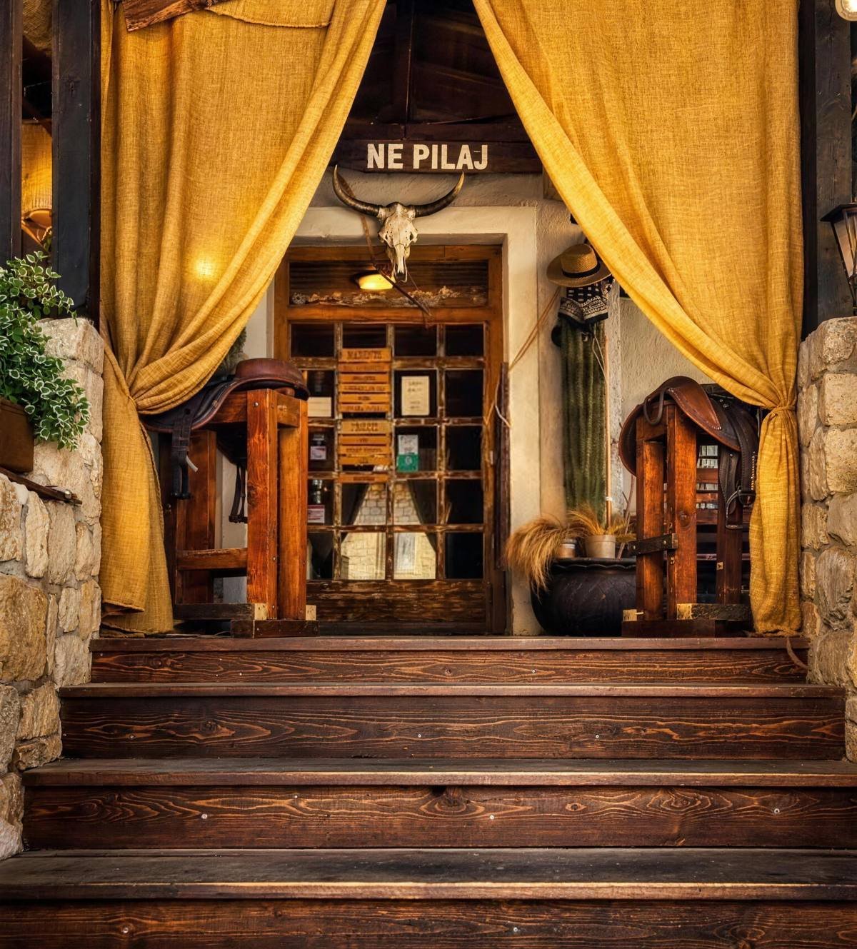 Entrance of Wild West Burger & Steak House in Trogir with wooden sign and jute curtains